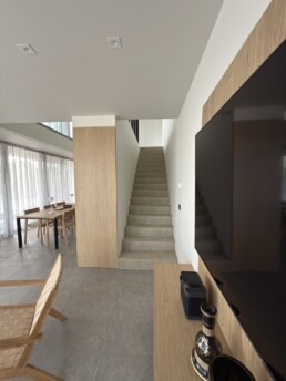 Villa 2 in Vourvourou, Halkidiki, featuring a staircase and open-plan interior with modern minimal design.