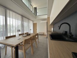 Villa 2 in Vourvourou, Halkidiki, featuring a staircase and open-plan interior with modern minimal design.