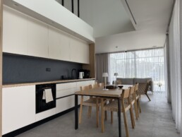 Villa 2 in Vourvourou, Halkidiki, featuring a kitchen and dining area connected to a bright living space.
